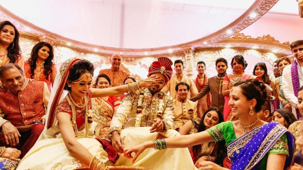 A newly wed couple happy in their Asian wedding ring finding ceremony