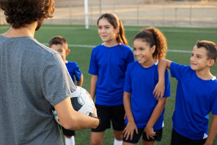 side-view-football-trainer-talking-kids