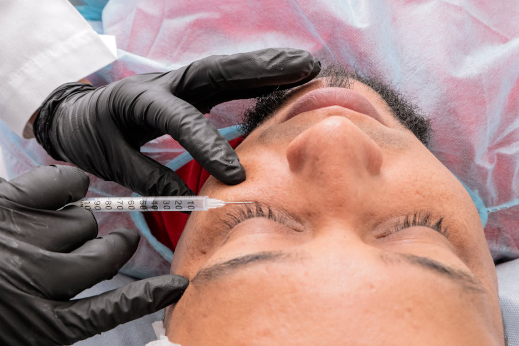 A patient getting injections to their face during a facial implant procedure