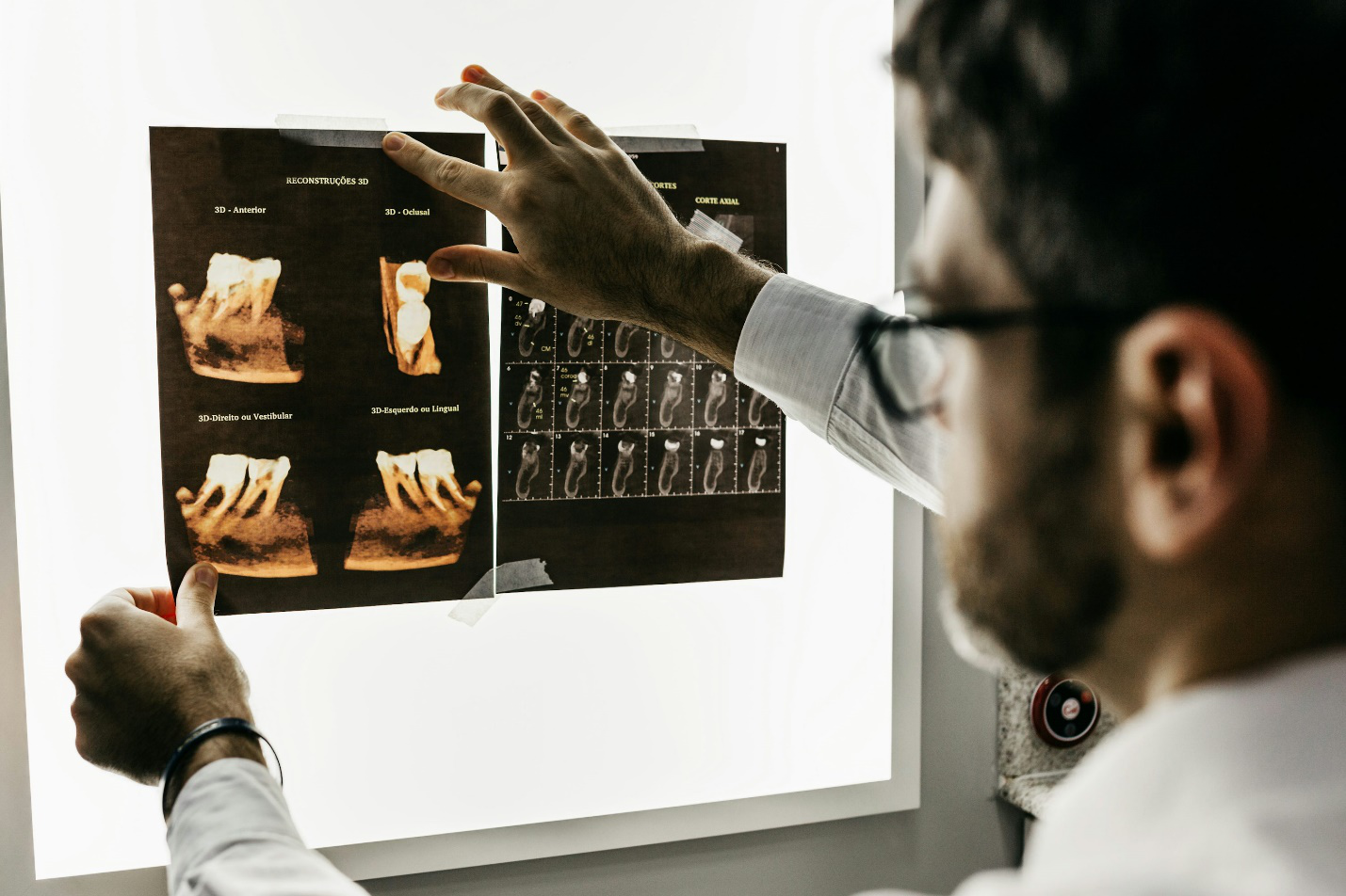 a dentist examining an Xray