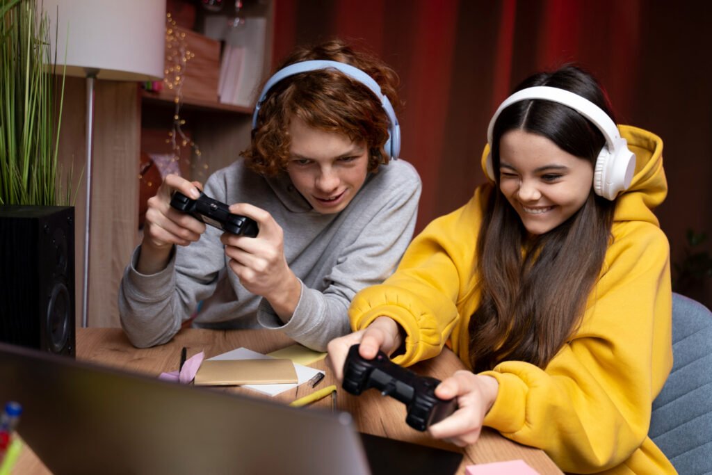 two girls sitting together on a couch and playing game