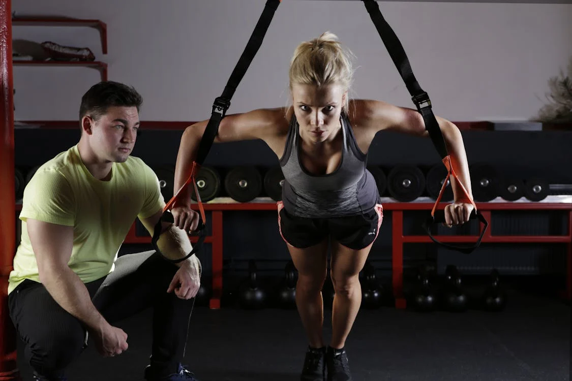 Woman doing exercise with a coach