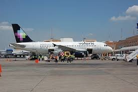 A large airplane is parked on the tarmac, ready for boarding and awaiting its next flight.