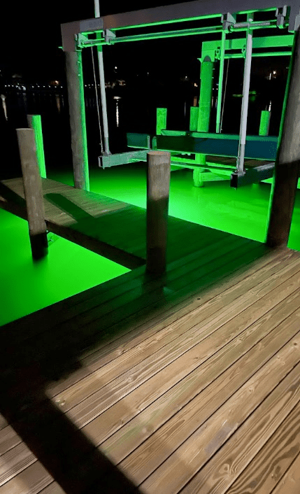 A dock illuminated by green LED lights