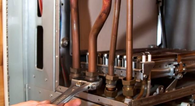 Hand holding Furnace Repair machine part