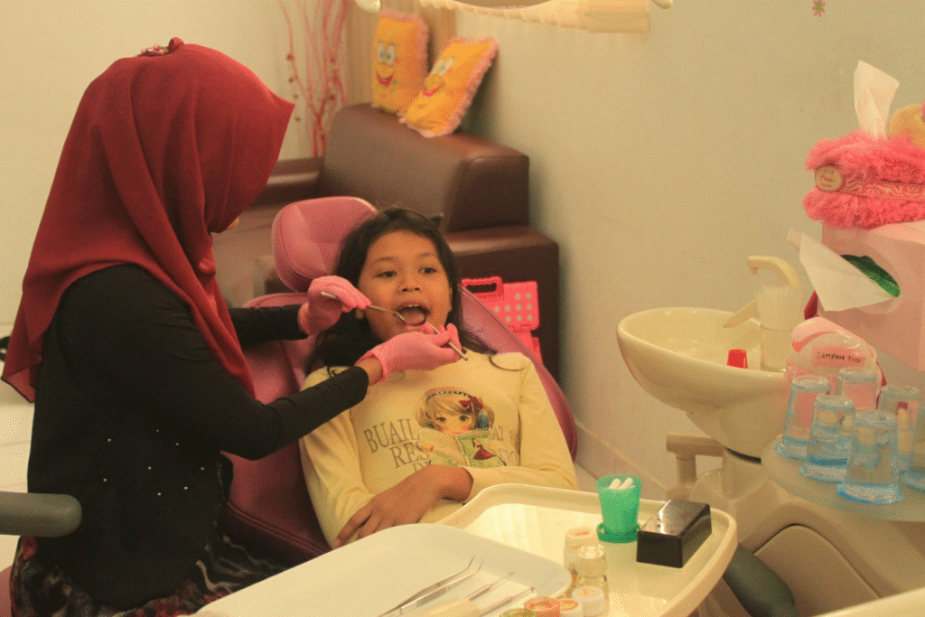 A dentist examining a child’s teeth