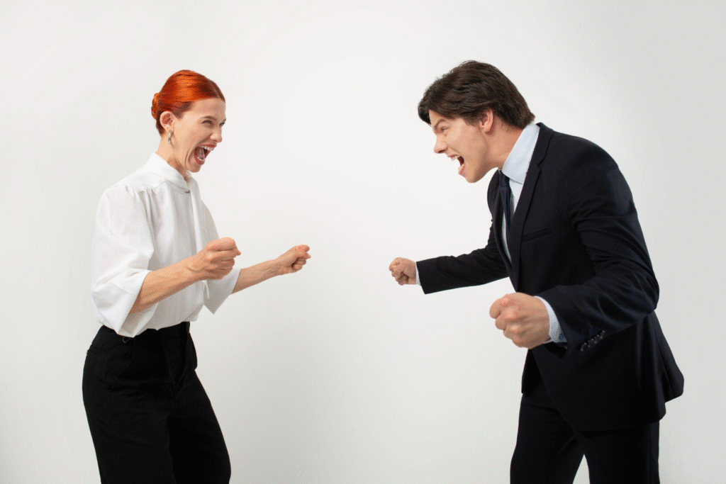 Two office professionals yelling at each other in a heated argument